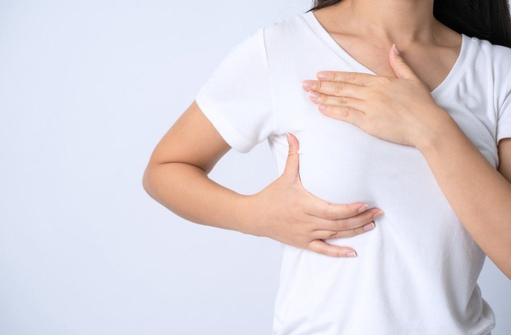 woman doing self-test for breast cancer